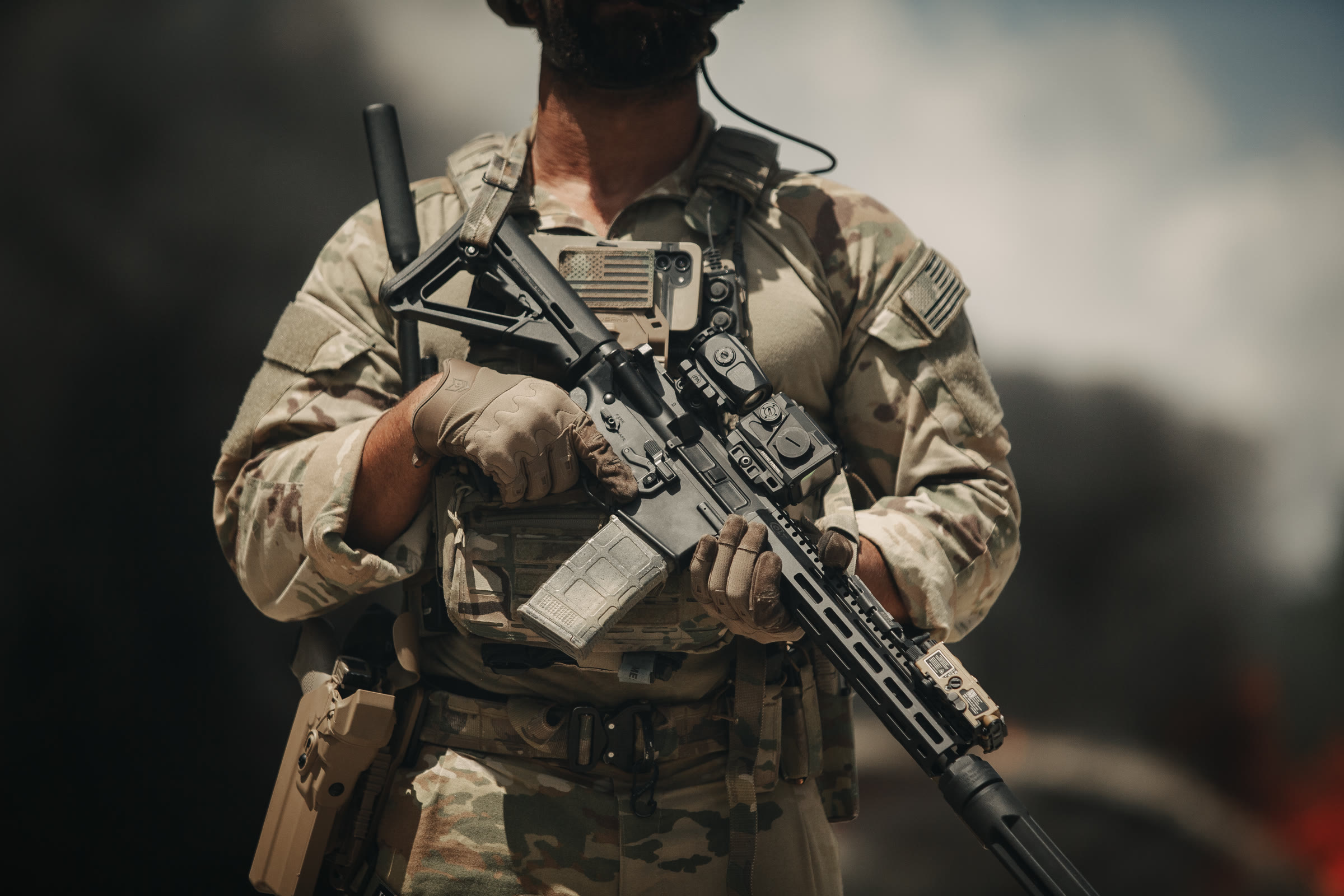 Suppressed 5.56 carbine carried across an operator's chest