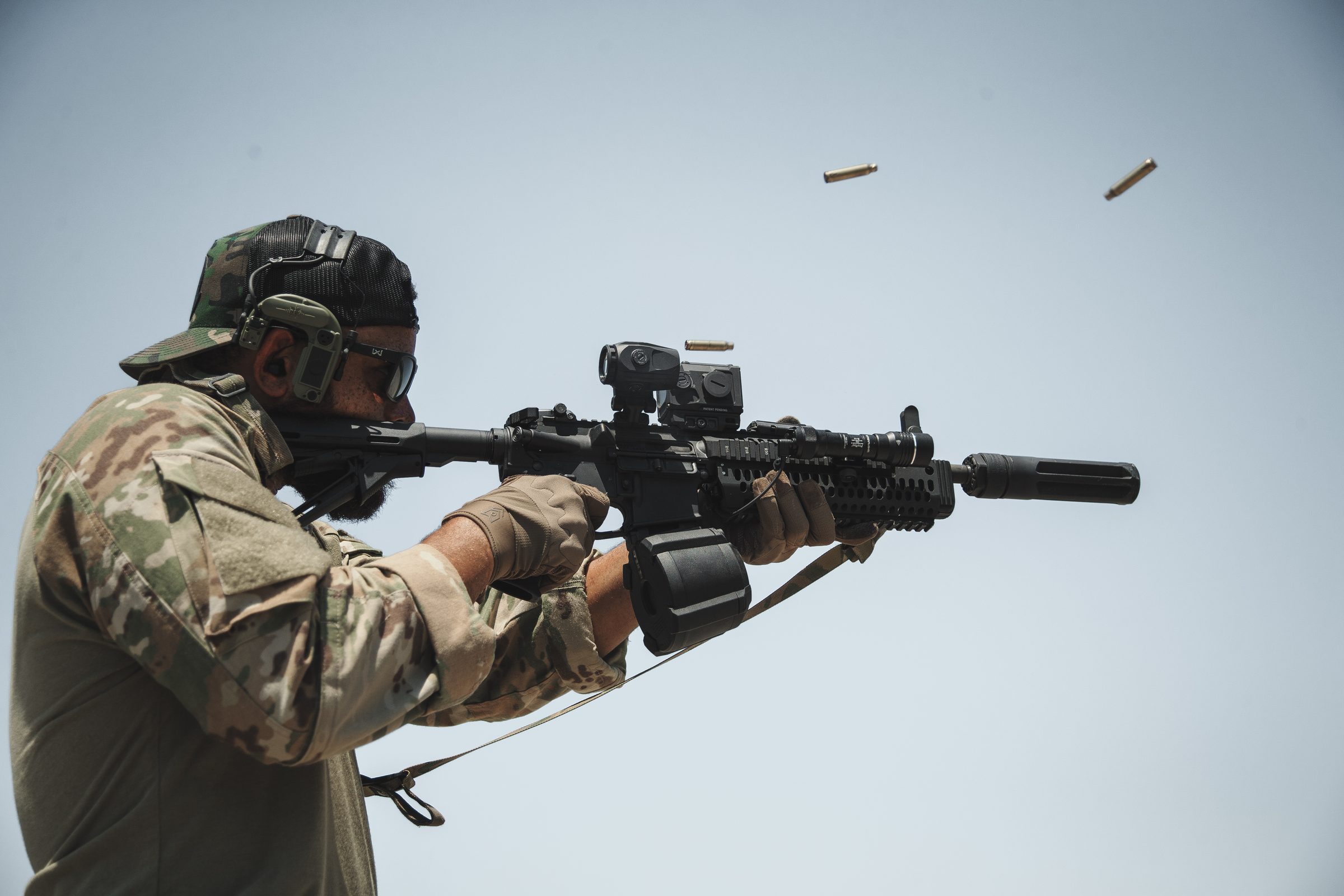 Suppressed rifle firing with brass ejecting mid-air